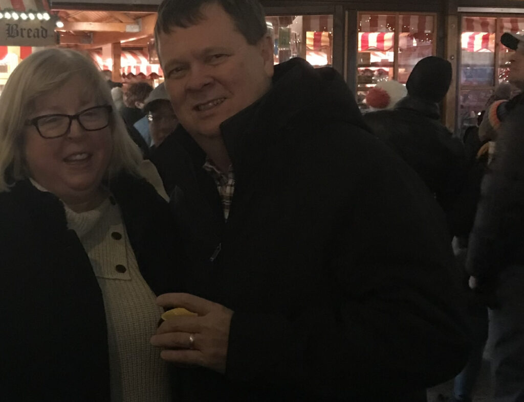 Husband and wife standing at chriskindl mart